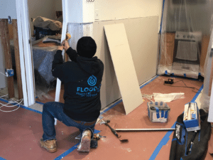 FloodCo expert doing restorative repairs
