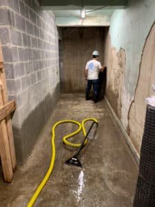 sewage cleanup job being performed by FloodCo technician