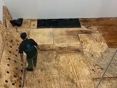 FloodCo expert removing floorboards as part of the mold remediation process