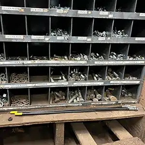 Pre-cleanup view of organized shelf with mechanical parts.