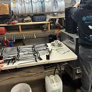 New Jersey cleaning professionals working on flood-damaged components.