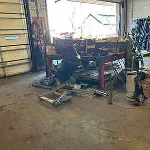 Ongoing commercial cleaning effort in a cluttered New Jersey shop.