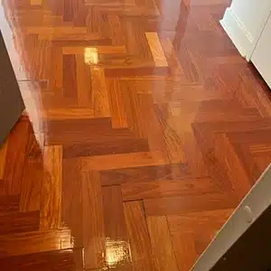 first coat of wood floor finish applied for floor restoration job in Teaneck, NJ