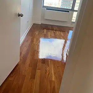 second coat of wood floor finish applied for floor restoration job in Teaneck, NJ